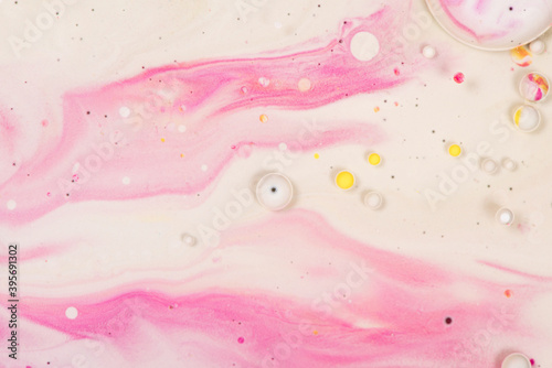 Hand painted background with mixed pink and yellow paints.Abstract fluid acrylic painting.Soft color texture.