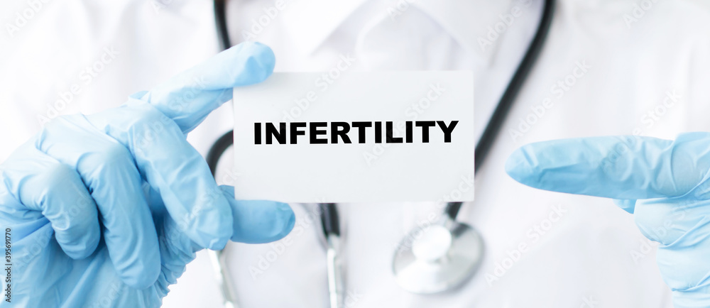 Doctor holding a card with text infertility, Medical concept Doctor holding a card with text infertility, Medical concept