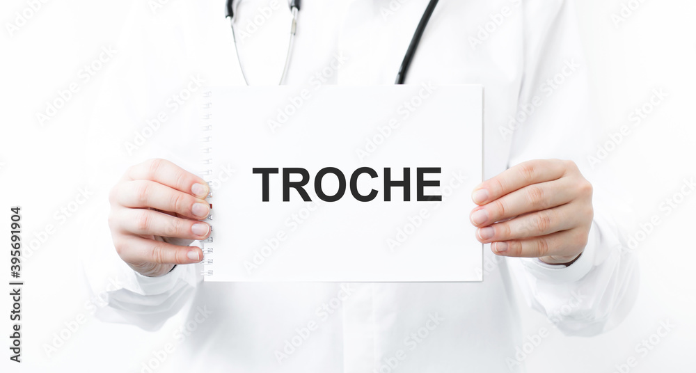 Doctor holding a card with text TROCHE, medical concept Doctor holding a card with text TROCHE, medical concept