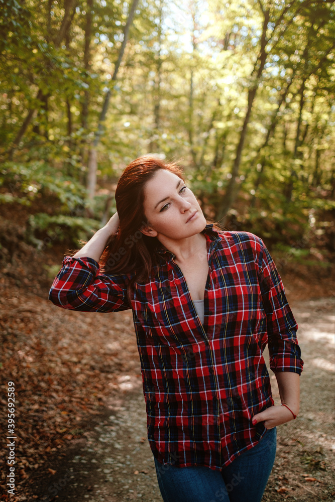 traveler hipster woman standing alone in autumn woods . traveler hipster woman standing alone in autumn woods .