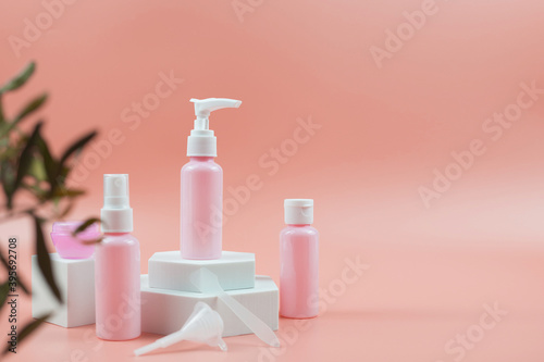 Pink cosmetic bottles for cream, gel, lotion. Skincare cosmetic concept.