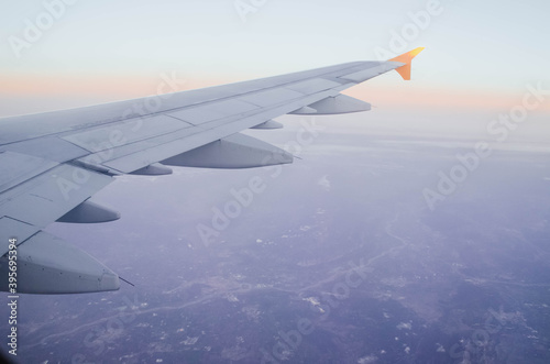 Landscape photography from the air with an airplane wing at sunrise