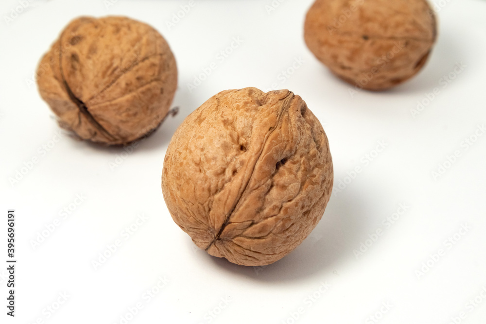Walnuts isolated on white background. Walnut kernels and whole walnuts Walnuts isolated on white background. Walnut kernels and whole walnuts