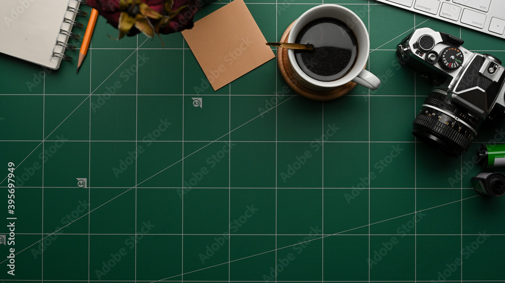 Workspace with coffee cup, camera, stationery and copy space on cutting board Workspace with coffee cup, camera, stationery and copy space on cutting board