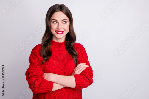 Photo portrait of curious smiling happy female student in sweater looking empty space isolated on pastel grey color background