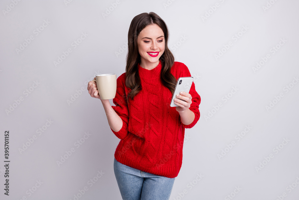 Photo portrait of female influencer keeping hot coffee cup browsing internet isolated on pastel grey color background Photo portrait of female influencer keeping hot coffee cup browsing internet isolated on pastel grey color background