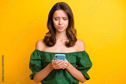 Canvas Print Photo of sad upset young woman look read bad news on smartphone isolated on shin