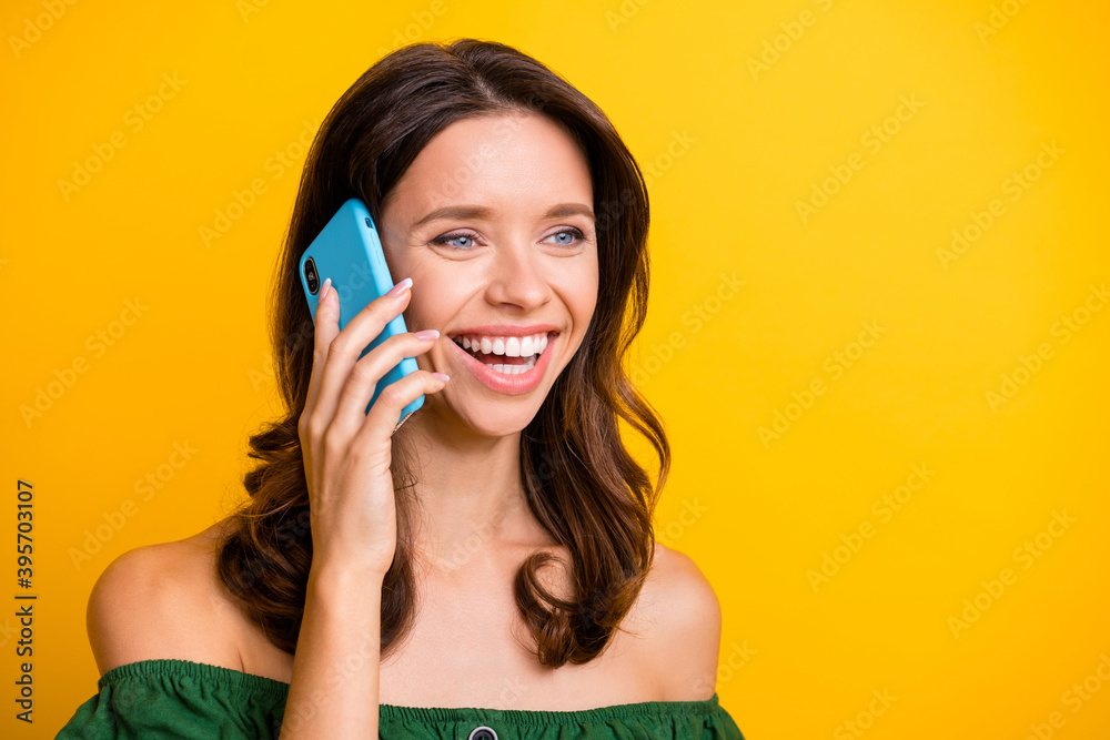 Photo of happy joyful charming young lady talk speak phone smile good mood isolated on yellow color background Photo of happy joyful charming young lady talk speak phone smile good mood isolated on yellow color background