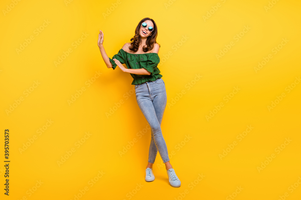 Full length photo of carefree young cool happy woman dance weekend break isolated on shine yellow color background Full length photo of carefree young cool happy woman dance weekend break isolated on shine yellow color background