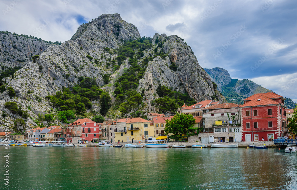 View of the embankment of the Cetina River and the mountains in the town of Omis.