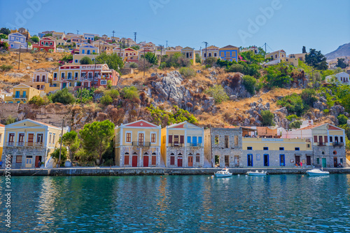View of beautiful bay with colorful houses on the hillside of the island of Symi. Greece