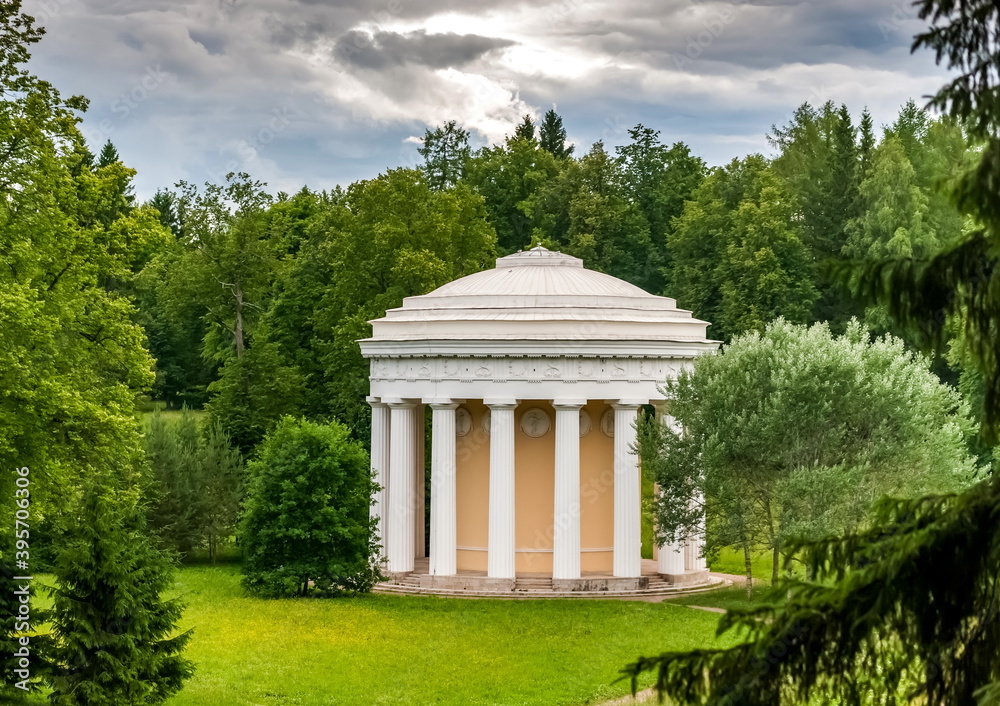 Summer landscape in a city Park with trees, pavilion, sky with clouds