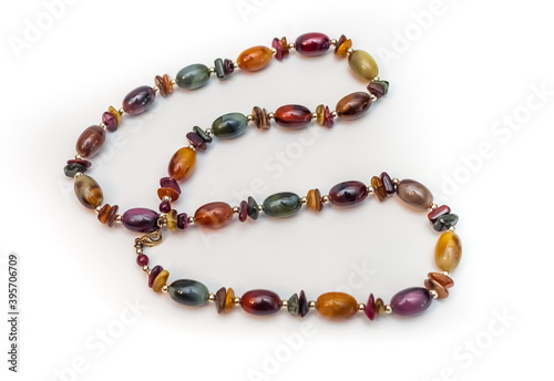 Purchased beads of colored stones close-up on a white background