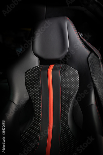 black luxury leather sports car seat with red strip in the middle