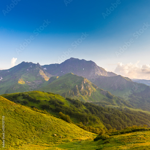 Beautiful mountain landscape at Caucasus mountains with clouds and blue sky