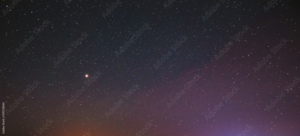 Night Starry Sky With Glowing Stars. Bright Glow Of Planet Venus In Sky Among Stars. Sky In Lights Of Sunset Dawn