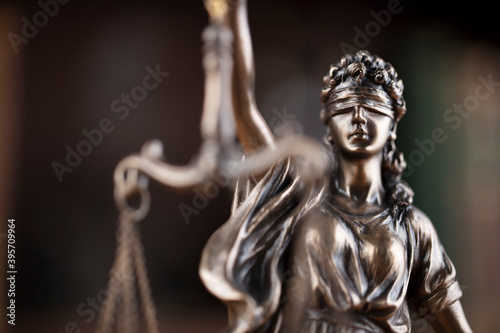 Justice concept. Judge chamber. Themis statue on brown shining desk.  © zolnierek