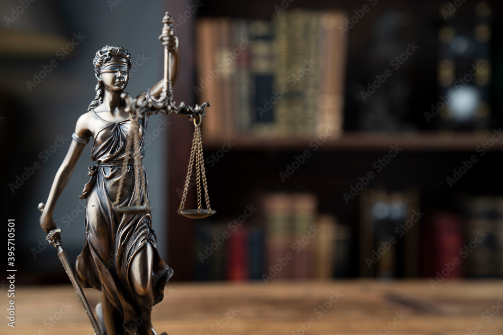 Justice concept. Judge chamber. Themis statue on brown shining desk. Justice concept. Judge chamber. Themis statue on brown shining desk.