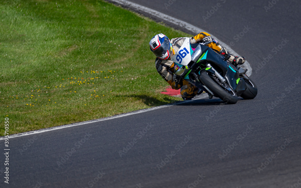 Naklejka premium A shot of a racing bike cornering on a track.