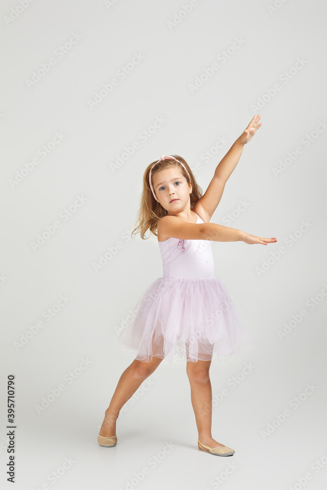 Charming little child girl dreams of becoming a ballerina. ballet dancer in pink tutu Charming little child girl dreams of becoming a ballerina. ballet dancer in pink tutu