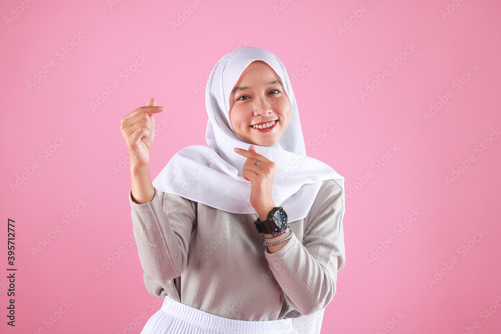 Fashion portrait of young beautiful asian muslim woman with wearing hijab isolated on pink background. Fashion portrait of young beautiful asian muslim woman with wearing hijab isolated on pink background.