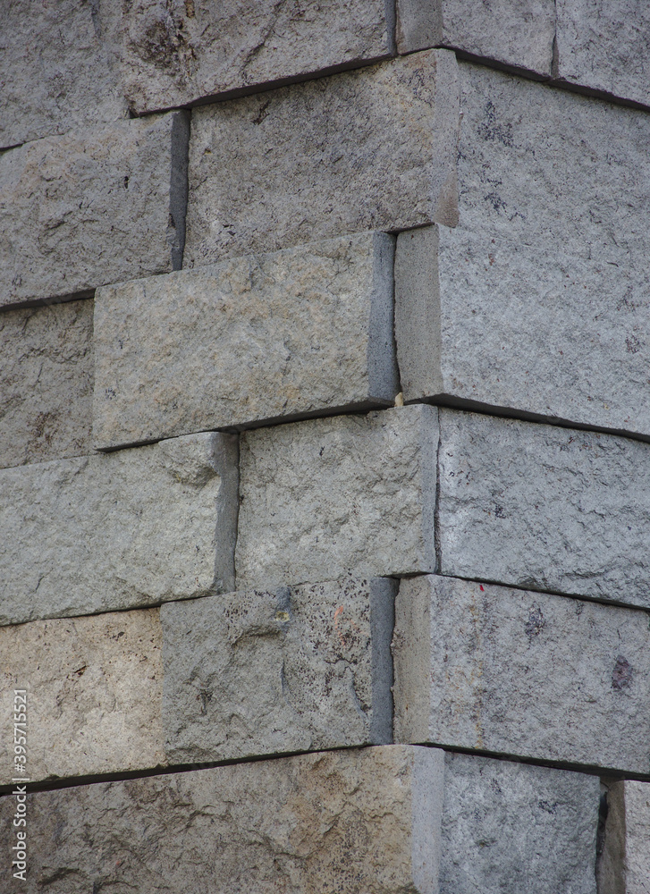 Fototapeta premium Vertical wall of bricks in cold tones