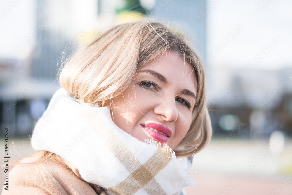 Beautiful blonde business woman in a long autumn coat