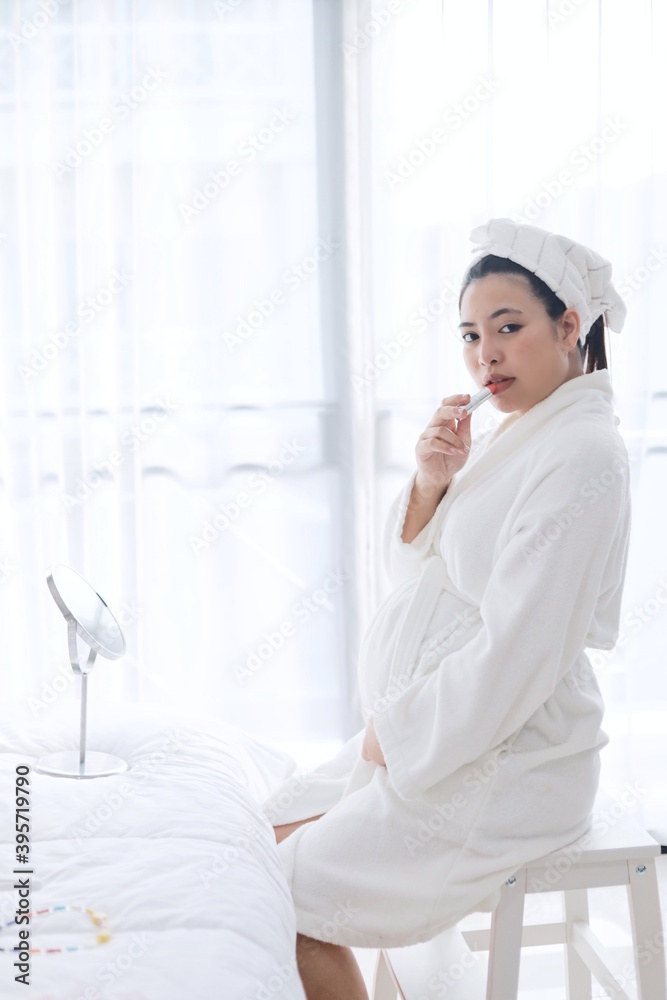 Beautiful pregnancy woman in bathrobe suit.
