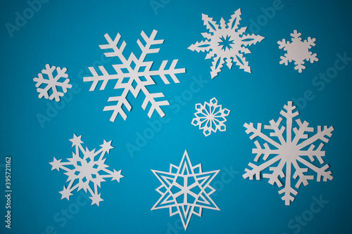 White paper snowflakes on light blue background