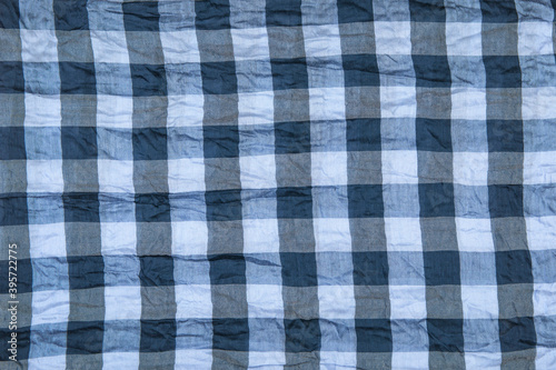 Crumpled knitted plaid. Soft and warm fabric crumpled in folds