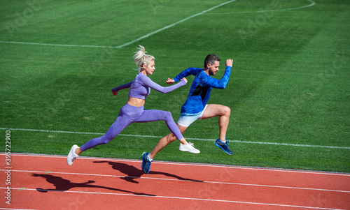 Sport is our life. runners on running track. challenge and competition. endurance. energy stamina. fit sporty people jumping. man and woman sport trainer run. fitness couple training outdoor