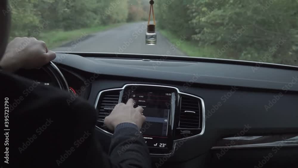 The driver and passenger drive in the car on the highway in the autumn time The driver and passenger drive in the car on the highway in the autumn time