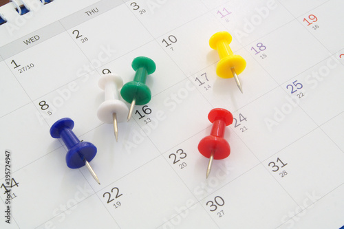 Planning concept, colorful push pins on calendar