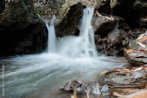 Great and beautiful waterfall in the green forest of Moldova  taking photo by long exposure