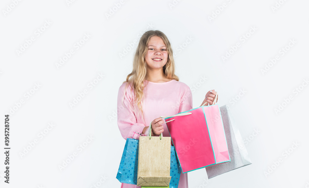 Shopping happiness. big sale. teen girl hold paper bag. buy gifts for holiday. shopaholic kid with purchase packages. happy child go shopping. black friday concept. kid on cyber monday Shopping happiness. big sale. teen girl hold paper bag. buy gifts for holiday. shopaholic kid with purchase packages. happy child go shopping. black friday concept. kid on cyber monday