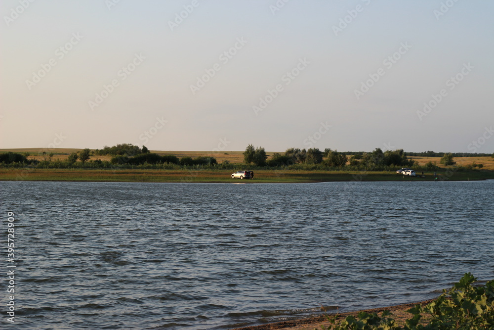 Naklejka premium sunset on the lake in summer