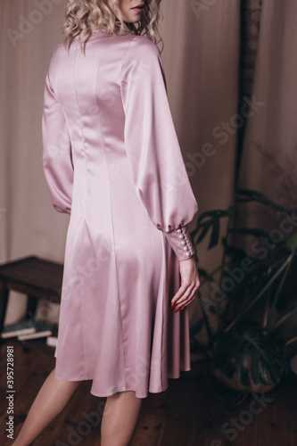 Woman in tender pink silk fashion dress 