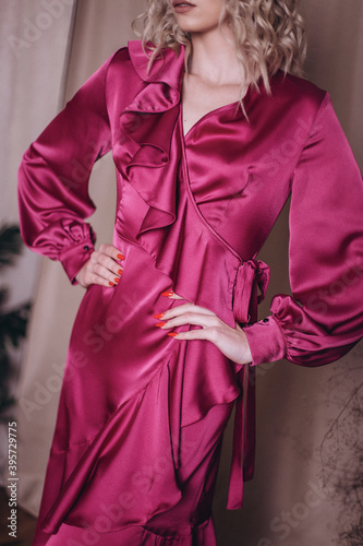 Woman in tender pink silk fashion dress 