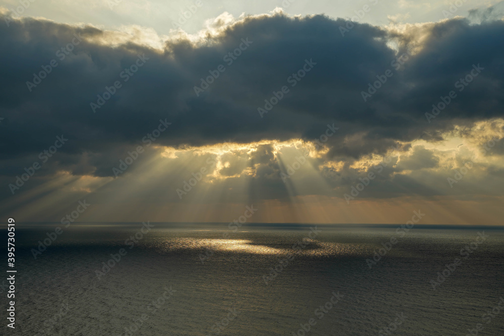 dark sky and sunbeams over the sea. dark sky and sunbeams over the sea.