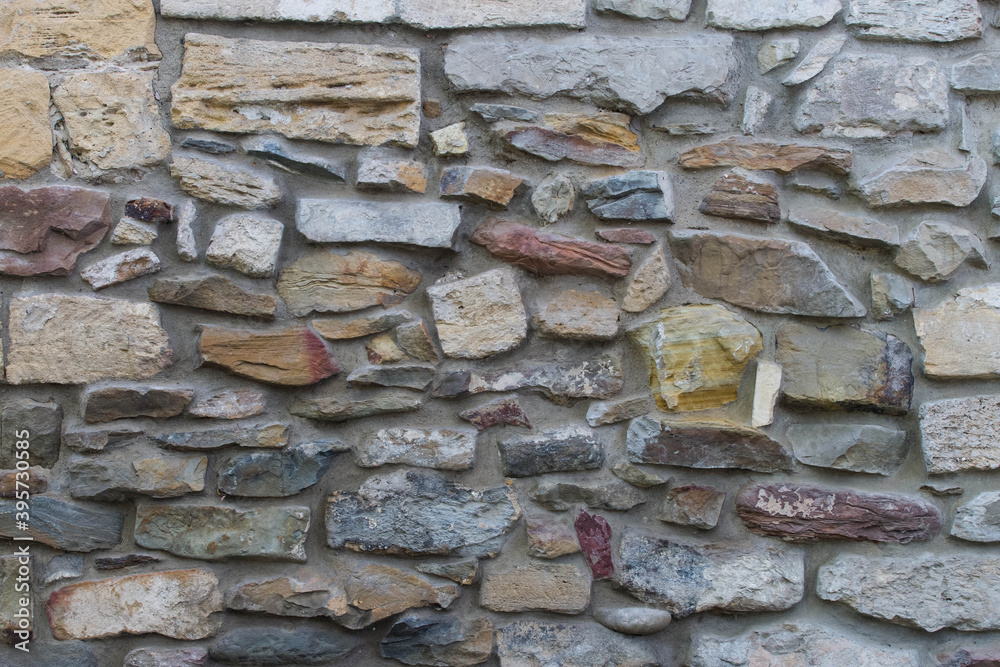 Masonry rock wall texture. Stones in foundation of old castle. Stone wall background for design or illustration