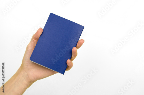 Blank blue card in a female hand on a white background