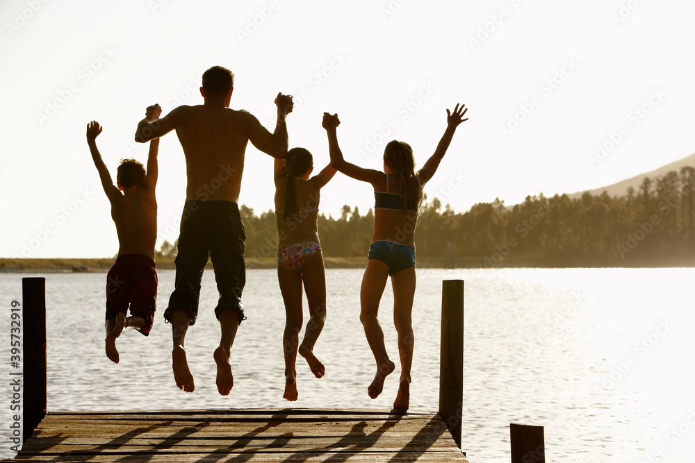Family Jumping Off A Jetty