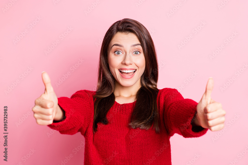 Photo of young pretty girl raise two hands show thumb-up excited look open mouth wear red sweater isolated pink color background Photo of young pretty girl raise two hands show thumb-up excited look open mouth wear red sweater isolated pink color background