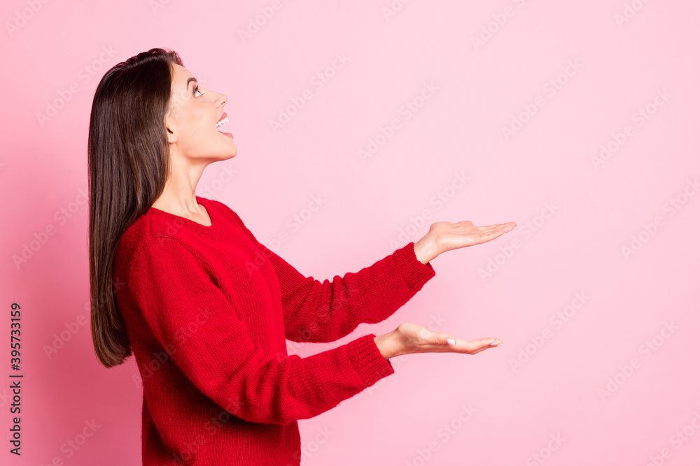 Profile photo of young pretty girl look up empty space catch snowflakes wear red pullover isolated pink color background Profile photo of young pretty girl look up empty space catch snowflakes wear red pullover isolated pink color background