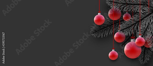 Realistic Xmas red baubles and spruce branches.
