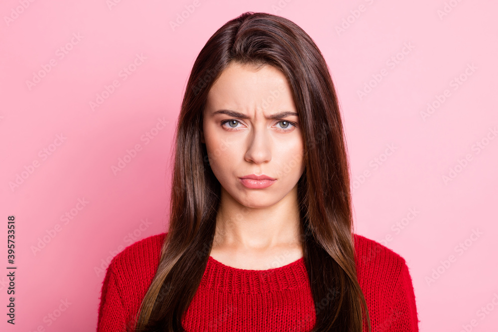 Photo portrait of capricious upset girl with straight brown hair looking at camera wearing knitted sweater isolated on pink pastel color background Photo portrait of capricious upset girl with straight brown hair looking at camera wearing knitted sweater isolated on pink pastel color background