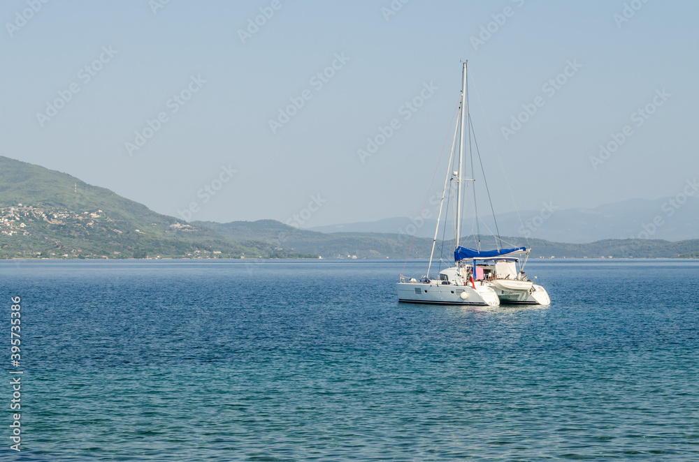 Evia island, Greece - July 01. 2020: Anchored sailboat on the island of Edipsos.