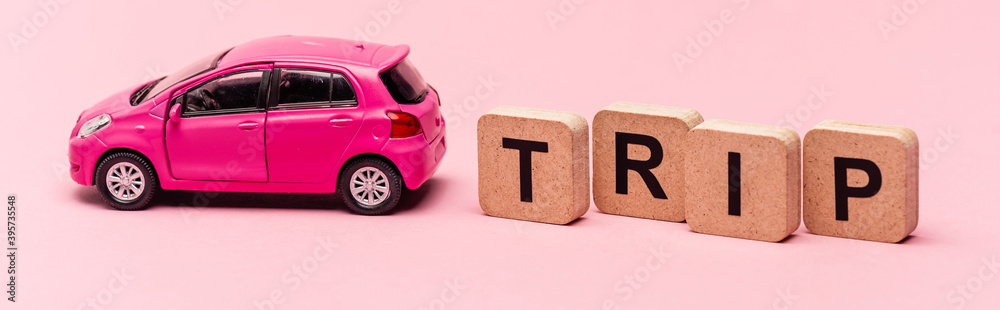 car and word trip on cubes on pink , banner