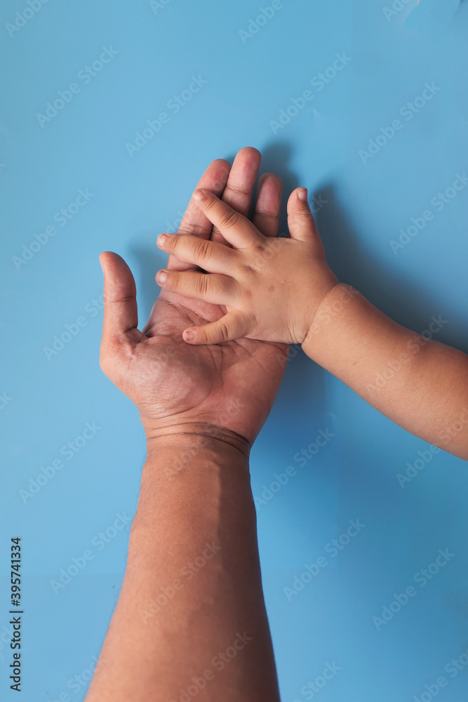 father holding hand of baby child, close up . father holding hand of baby child, close up .
