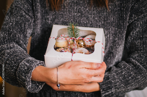 Christmas gift box with cookies in hands